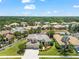 An elevated view shows the home set in a residential community with mature trees at 1743 Pinyon Pine Dr, Sarasota, FL 34240