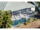Aerial view of screened-in pool and lanai, showcasing outdoor living space and surrounding greenery at 1743 Pinyon Pine Dr, Sarasota, FL 34240
