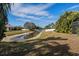Landscaped backyard with a calming water view and well-maintained grass at 1743 Pinyon Pine Dr, Sarasota, FL 34240