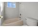 Bathroom featuring a bathtub, toilet and window at 1743 Pinyon Pine Dr, Sarasota, FL 34240