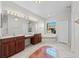 Elegant bathroom with double vanity, soaking tub, and a large window providing natural light at 1743 Pinyon Pine Dr, Sarasota, FL 34240