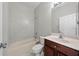 Traditional bathroom featuring a shower-tub combo, vanity, and a ceramic tile floor at 1743 Pinyon Pine Dr, Sarasota, FL 34240