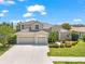 Charming home featuring a three-car garage, tile roof, and well-manicured landscaping at 1743 Pinyon Pine Dr, Sarasota, FL 34240