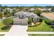 Charming home featuring a three-car garage, tile roof, and well-manicured landscaping at 1743 Pinyon Pine Dr, Sarasota, FL 34240