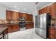 Well-equipped kitchen featuring stainless steel appliances, dark wood cabinets, and ample counter space at 1743 Pinyon Pine Dr, Sarasota, FL 34240