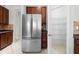 Kitchen featuring stainless steel refrigerator and pantry with wire shelving for ample food storage at 1743 Pinyon Pine Dr, Sarasota, FL 34240