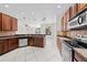 Spacious kitchen with stainless steel appliances, dark wood cabinets, and open access to the living area at 1743 Pinyon Pine Dr, Sarasota, FL 34240