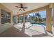Covered lanai with ample space for outdoor seating and dining, overlooking the refreshing pool and landscaped backyard at 1743 Pinyon Pine Dr, Sarasota, FL 34240
