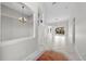 Spacious living room featuring neutral walls, tile flooring and elegant chandeliers at 1743 Pinyon Pine Dr, Sarasota, FL 34240