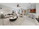 Open-concept living room boasts a ceiling fan, breakfast bar, and seamless flow to the dining area at 1743 Pinyon Pine Dr, Sarasota, FL 34240