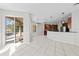 Bright living room with tile flooring and an open layout leading to a modern kitchen and backyard pool at 1743 Pinyon Pine Dr, Sarasota, FL 34240