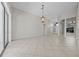 Spacious living area with tile flooring, plenty of light, and elegant chandelier at 1743 Pinyon Pine Dr, Sarasota, FL 34240