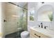 Bathroom with beige tile shower and black pebble floor at 2326 Gull Ln, Sarasota, FL 34237