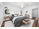 Spacious bedroom featuring a chandelier, gray bedding, and light wood accents at 2326 Gull Ln, Sarasota, FL 34237