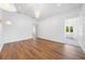 Bright bedroom with modern chandelier and doorway leading to an ensuite bathroom at 2326 Gull Ln, Sarasota, FL 34237