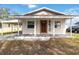 Updated bungalow exterior with a covered porch and a well-maintained lawn at 2410 13Th W St, Palmetto, FL 34221