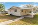 House exterior with covered patio and walkway at 2410 13Th W St, Palmetto, FL 34221