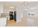 Modern kitchen with white cabinets, black appliances, and a light countertop at 2410 13Th W St, Palmetto, FL 34221