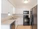Updated kitchen featuring white cabinets, black appliances, and tile floors at 2410 13Th W St, Palmetto, FL 34221