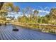 Expansive deck with wooden railings offering scenic views of lush surroundings and blue skies at 2961 Homasassa Rd, Sarasota, FL 34239
