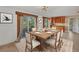 Dining room with a wood table set for six and sliding glass doors to the outside at 2961 Homasassa Rd, Sarasota, FL 34239