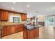 Spacious kitchen featuring an island, granite countertops, and stylish tile backsplash at 2961 Homasassa Rd, Sarasota, FL 34239