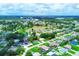 Aerial view of a residential neighborhood with lush greenery and a central lake at 300 Coral Rd, Venice, FL 34293