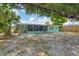 Home's backyard view, showing the gravel and tree at 300 Coral Rd, Venice, FL 34293