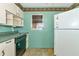 View of kitchen with dishwasher, refrigerator, and window at 3128 Bay St, Sarasota, FL 34237