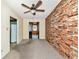 Living room with brick wall and access to kitchen at 3128 Bay St, Sarasota, FL 34237