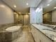 Elegant bathroom with granite double vanity, soaking tub and walk in shower at 3404 79Th Street W Cir # 203, Bradenton, FL 34209