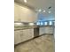 Modern kitchen with white cabinets, granite countertops, and stainless steel appliances at 3404 79Th Street W Cir # 203, Bradenton, FL 34209