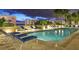 Inviting swimming pool with lounge chairs and city views at night at 35 Watergate Dr # 804, Sarasota, FL 34236