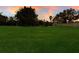 Large grassy backyard with mature trees at 3618 Summerwind Cir, Bradenton, FL 34209