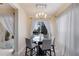 Bright breakfast nook with glass table and chairs, overlooking a pool at 3618 Summerwind Cir, Bradenton, FL 34209