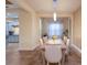 Dining room with light beige walls, wood table, and view of kitchen at 3618 Summerwind Cir, Bradenton, FL 34209