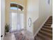 Bright entryway with high ceilings, tile floors, and staircase at 3618 Summerwind Cir, Bradenton, FL 34209