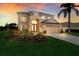 Two-story house with landscaped yard, at dusk at 3618 Summerwind Cir, Bradenton, FL 34209