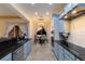 Open kitchen with light blue cabinets, granite counters, and stainless steel appliances at 3618 Summerwind Cir, Bradenton, FL 34209