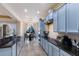 Modern kitchen with light blue cabinets, granite countertops, and stainless steel appliances at 3618 Summerwind Cir, Bradenton, FL 34209