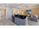 Open floor plan with kitchen island, gray cabinets, and living room at 3618 Summerwind Cir, Bradenton, FL 34209