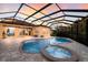 Inviting pool and spa with screened enclosure, perfect for relaxation at 3618 Summerwind Cir, Bradenton, FL 34209