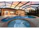Screened pool, spa, and patio at sunset at 3618 Summerwind Cir, Bradenton, FL 34209