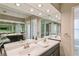 Double vanity bathroom with large mirrors and modern fixtures at 3808 El Conquistador Pkwy, Bradenton, FL 34210