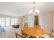 Bright dining room with wood table and access to living room at 3808 El Conquistador Pkwy, Bradenton, FL 34210