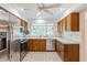 Kitchen features wood cabinets, stainless steel appliances, and hexagon tile floor at 3808 El Conquistador Pkwy, Bradenton, FL 34210
