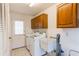 Laundry room with washer, dryer, cabinets, and sink at 3808 El Conquistador Pkwy, Bradenton, FL 34210