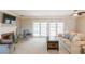 Spacious living room with fireplace, large windows, and access to pool area at 3808 El Conquistador Pkwy, Bradenton, FL 34210