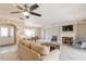 Spacious living room with fireplace, large windows, and access to pool area at 3808 El Conquistador Pkwy, Bradenton, FL 34210