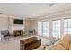 Spacious living room with fireplace, large windows, and access to pool area at 3808 El Conquistador Pkwy, Bradenton, FL 34210
